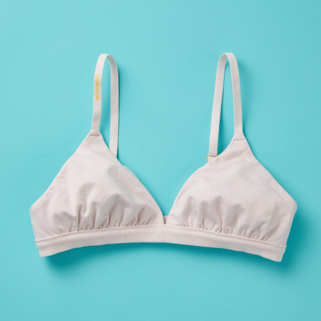 Yellowberry’s Joey Bra for Girls: A bra that grows with you. Made with double layered cotton-spandex fabric (great for sensitive skin!) just for girls beginning to develop. For girls, by girls! Front laydown light pink.