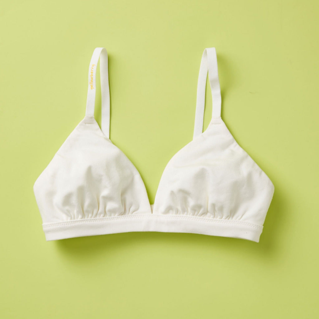Yellowberry’s Joey Bra for Girls: A bra that grows with you. Made with double layered cotton-spandex fabric (great for sensitive skin!) just for girls beginning to develop. For girls, by girls! Front laydown white..